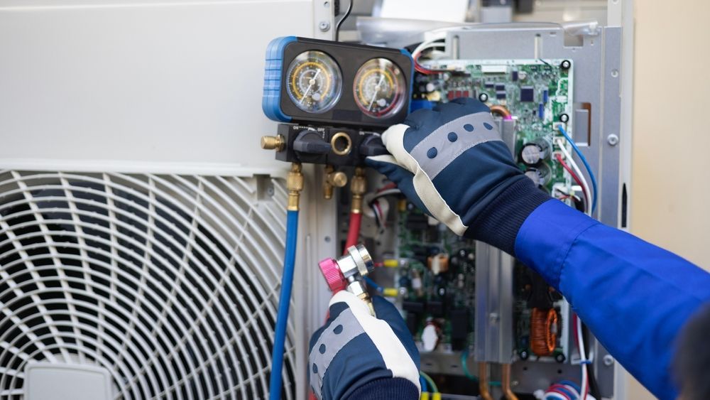 A man is working on an air conditioner.