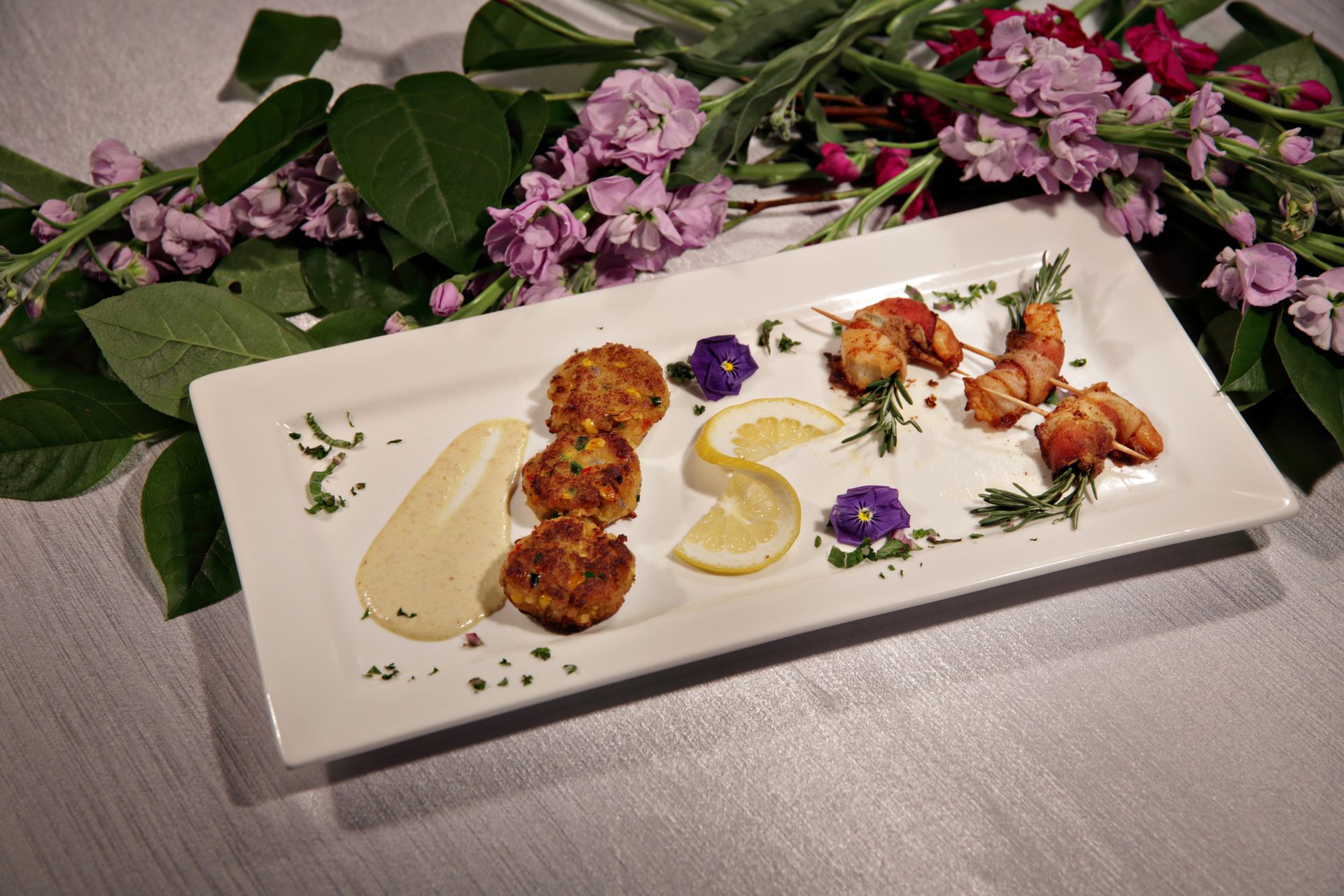 A plate of food with flowers in the background
