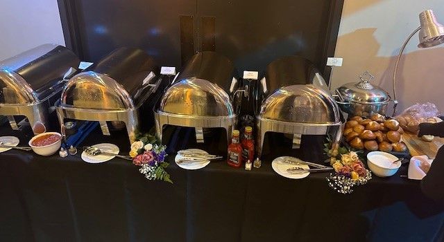 A buffet table with a lot of food on it.