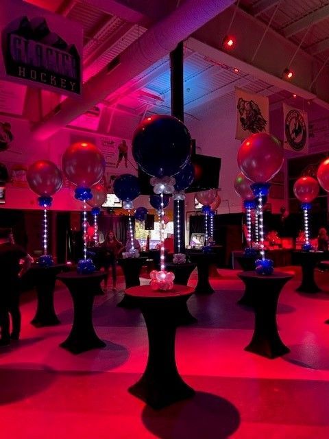 A room filled with tables and balloons and a sign that says runner on it