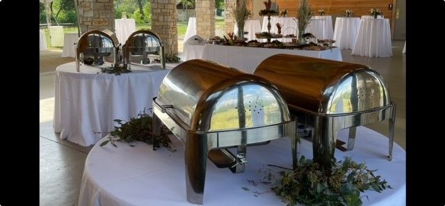 Two stainless steel chafing dishes are sitting on a table.