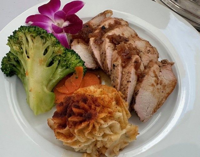 A plate of food with broccoli carrots and mashed potatoes