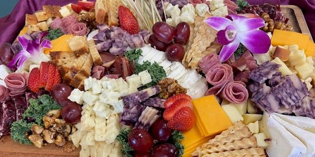 A large cutting board filled with lots of different types of food.