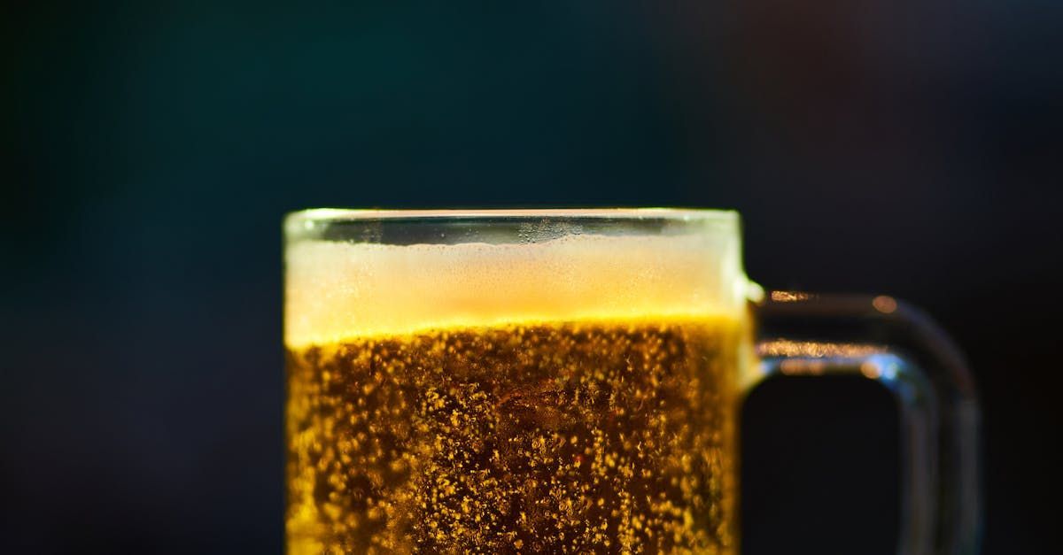 A close up of a glass of beer on a table.