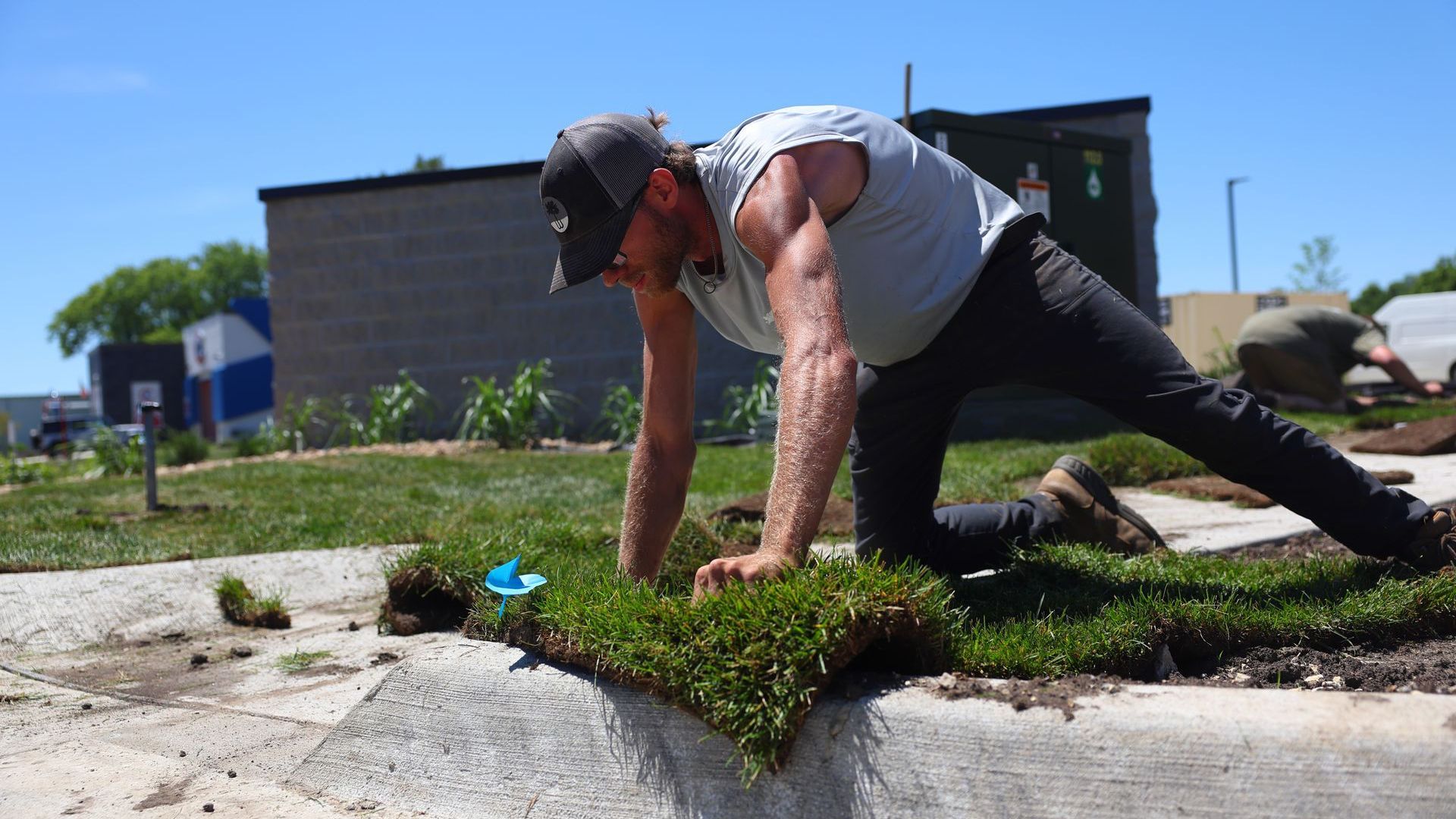 A Wells Hollow employee installing sod.