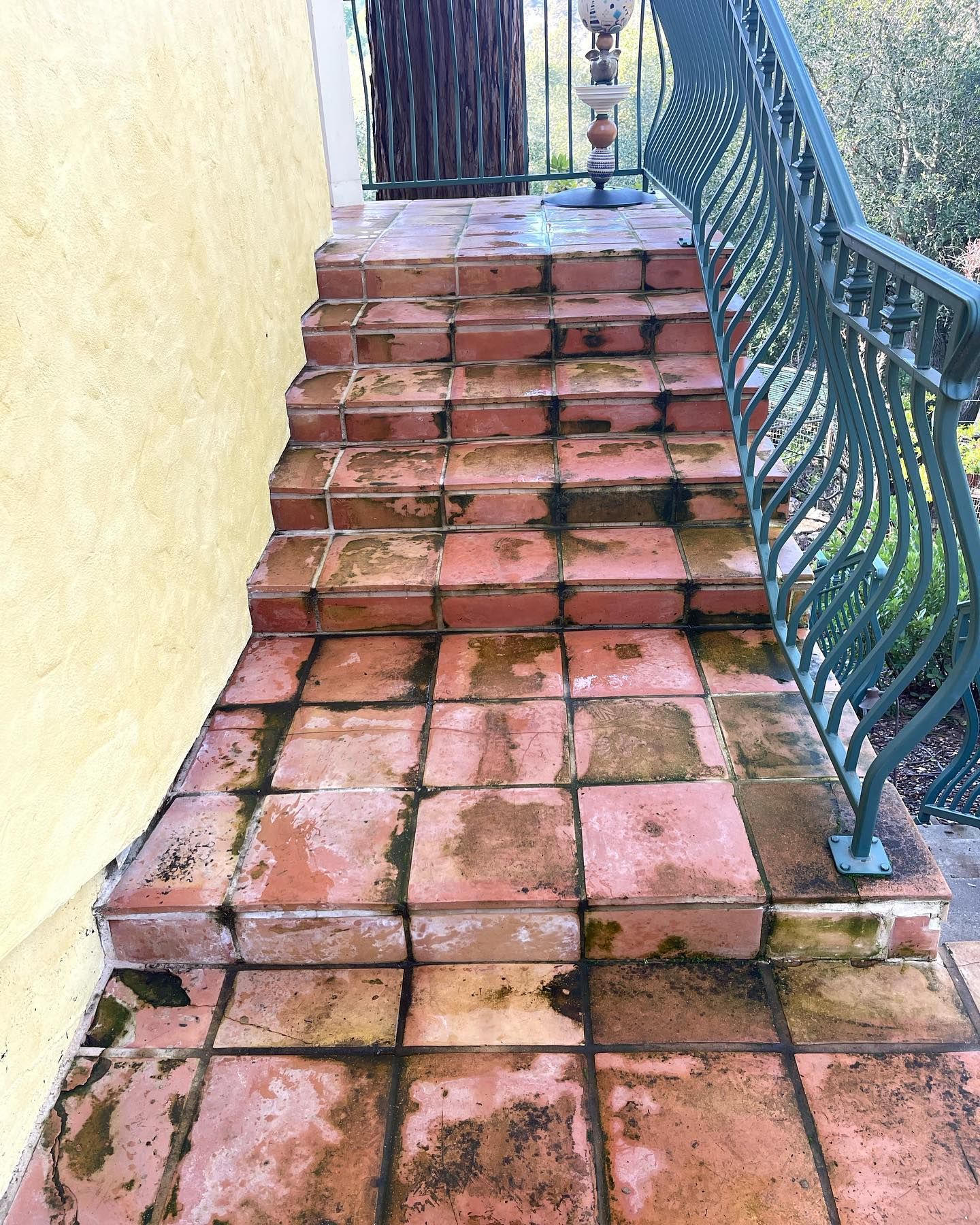 A set of stairs leading up to a balcony with a railing.