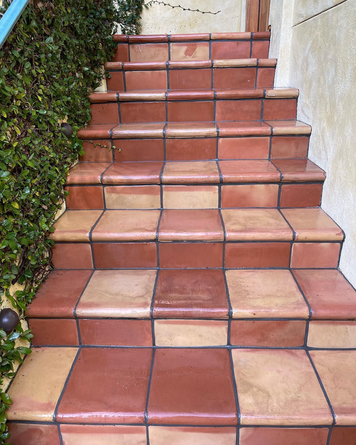 A set of tiled stairs leading up to a building.