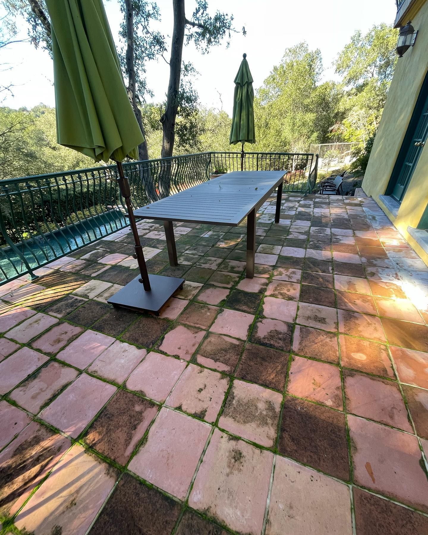 A patio with a table and umbrellas on it