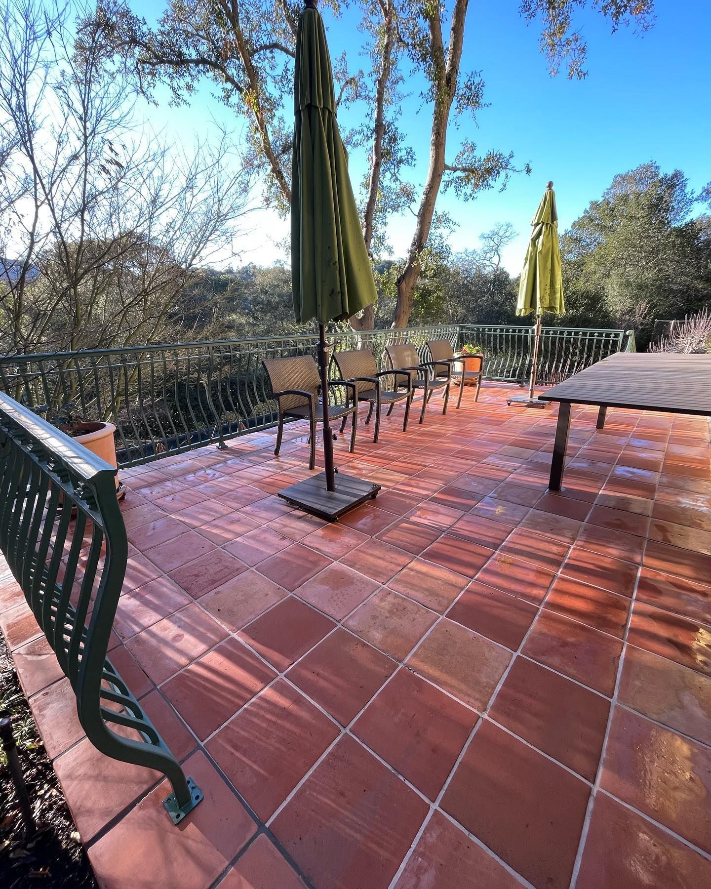 A patio with umbrellas and chairs on it