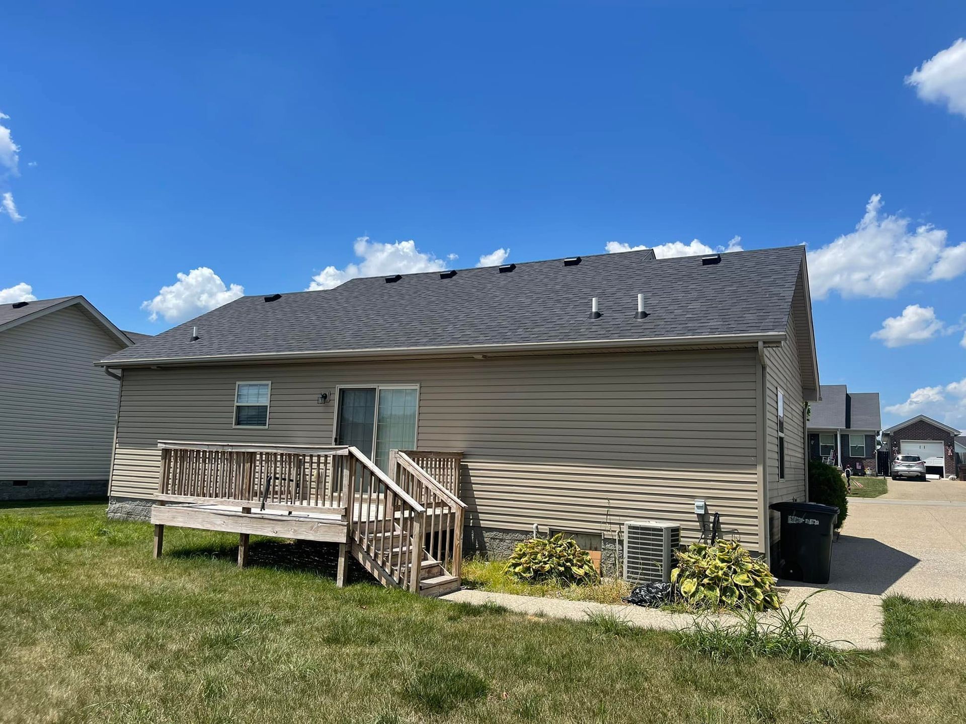 The back of a house with a deck and stairs.