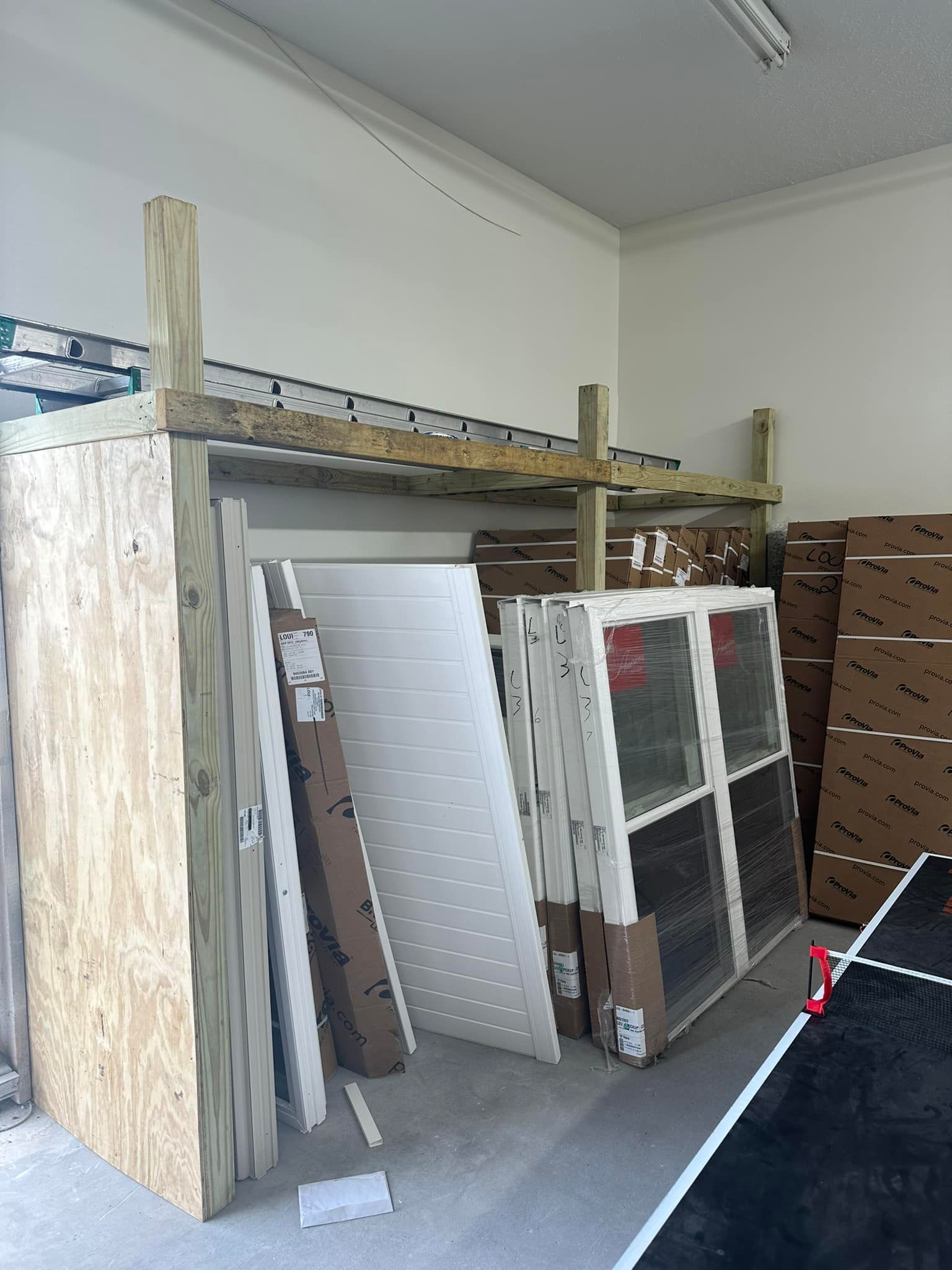 A room filled with lots of boxes and pieces of wood.