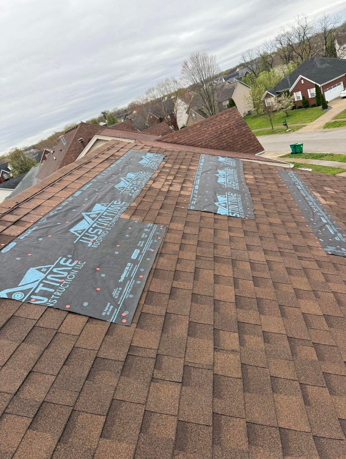 A roof with shingles being installed on it.