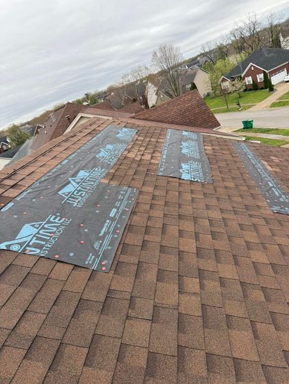 A roof with shingles being installed on it.