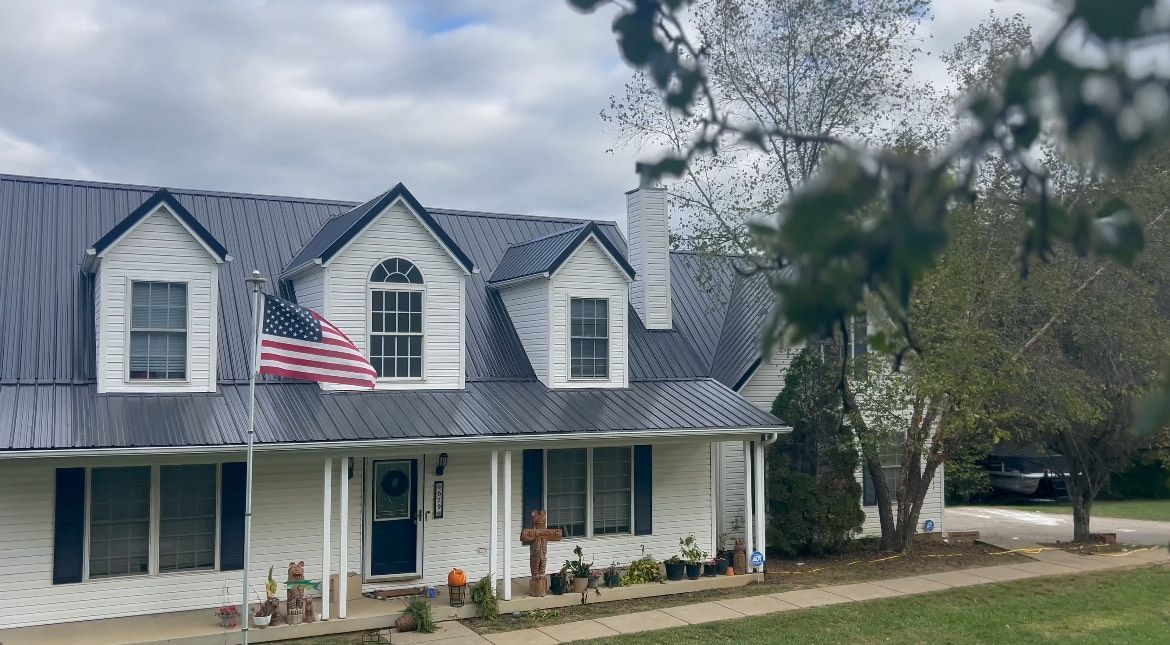 The back of a house with a deck and stairs.