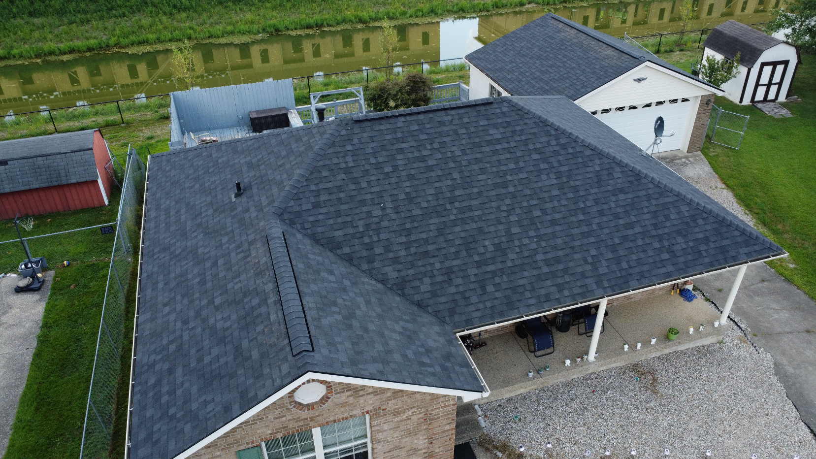 An aerial view of a house with a roof that is being repaired.