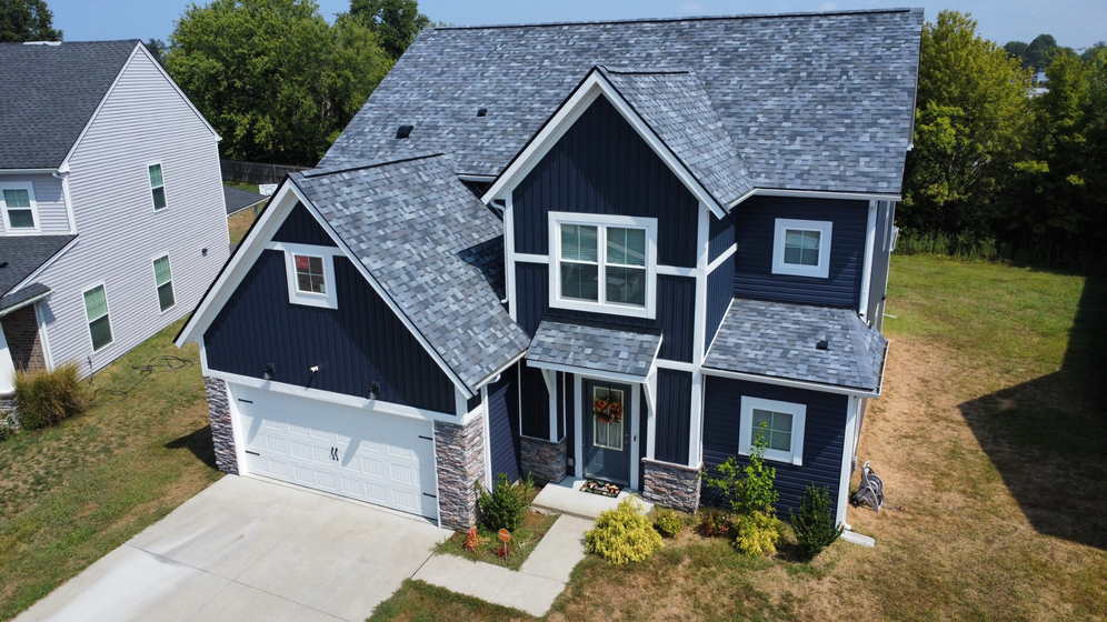 A roof with shingles being installed on it.