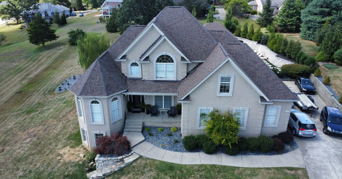 An aerial view of a house with a roof that is being repaired.