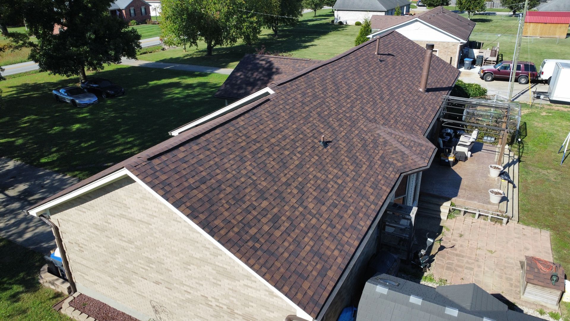 An aerial view of a house with a blue roof and a wooden fence.