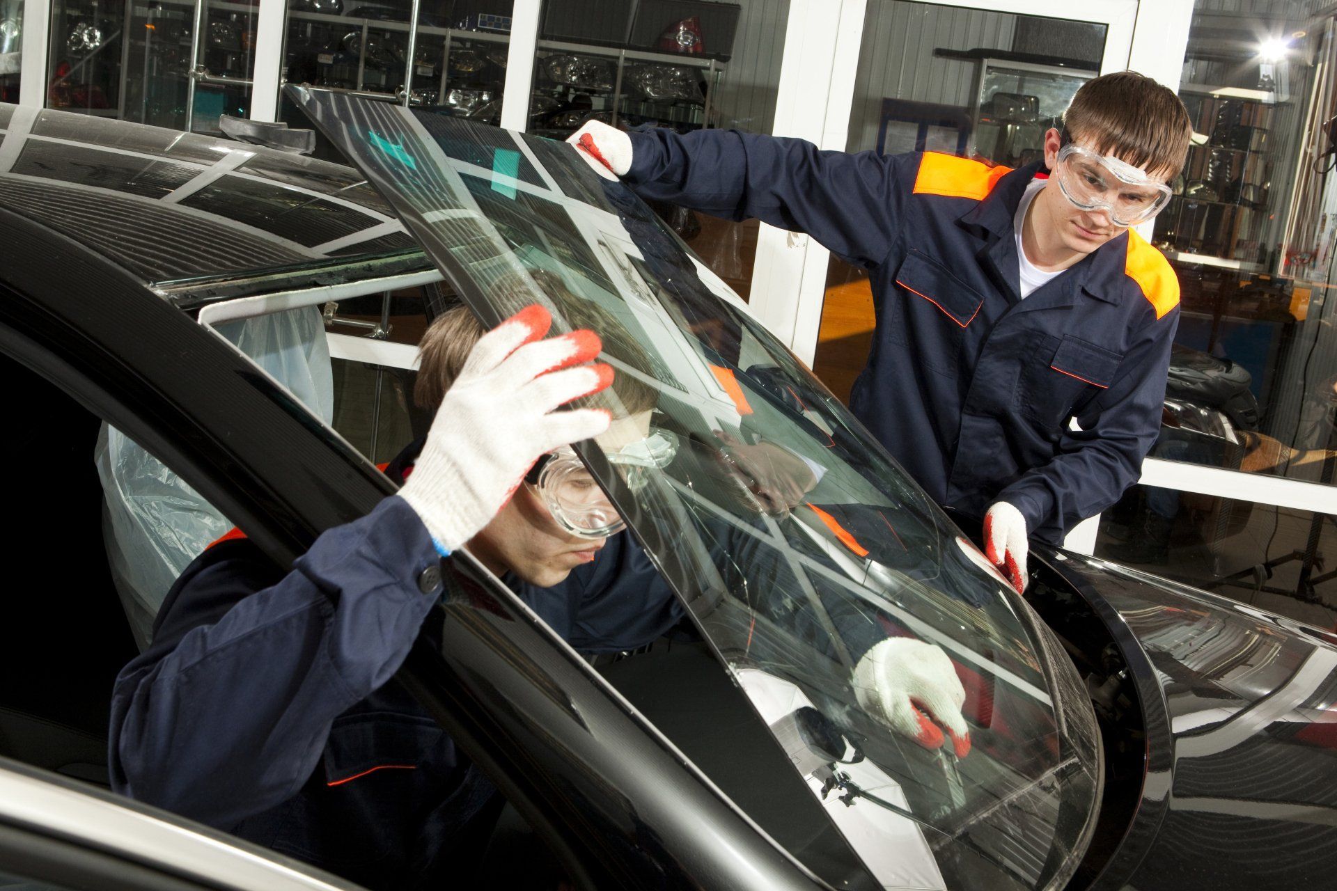 two men installing automotive glass