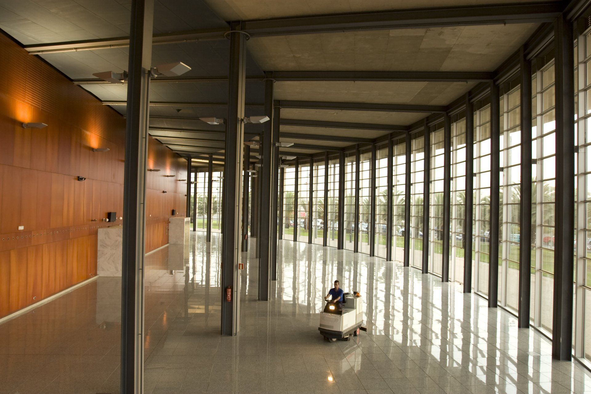 Man riding inside a big room full of window glass