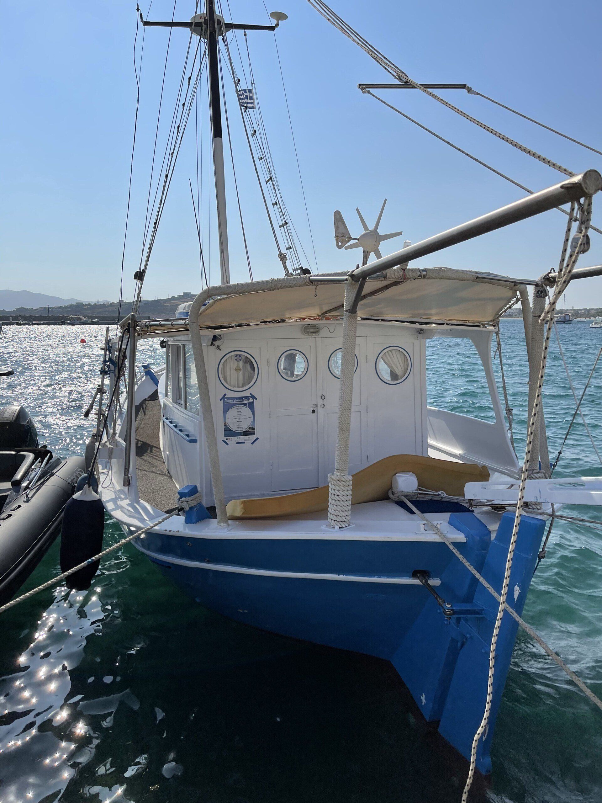 A blue and white boat is docked in the water