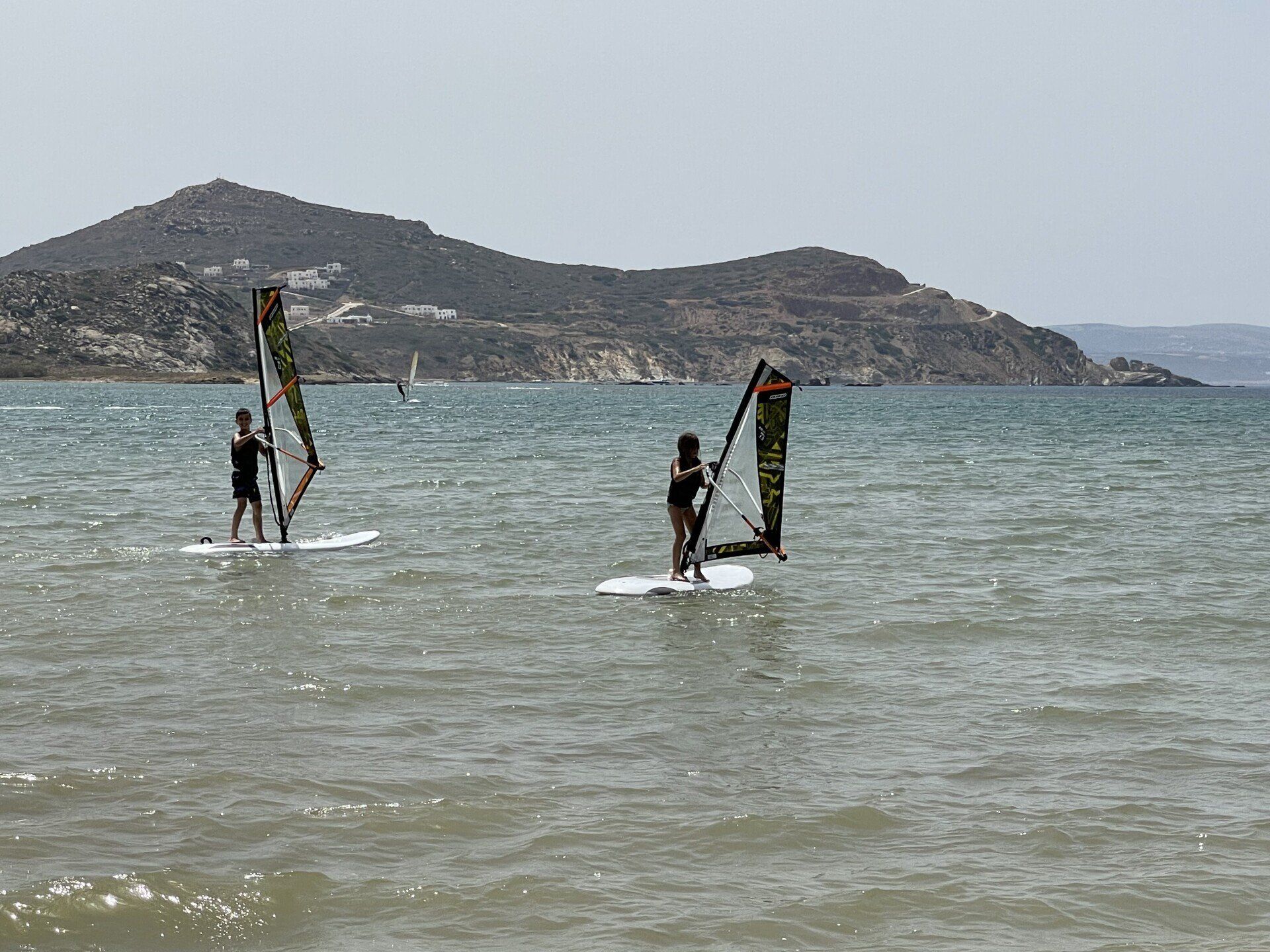 A group of people are windsurfing in the ocean.