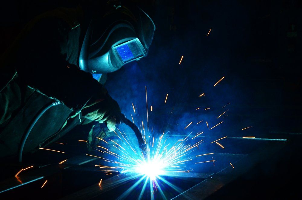 Welders Working at the Factory Made Metal — Cairns Electrical Rewinds & Repairs In Bungalow, QLD