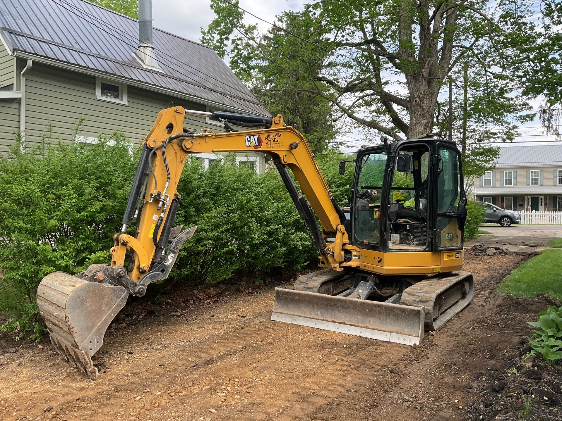 A man is operating an excavator on a construction site.