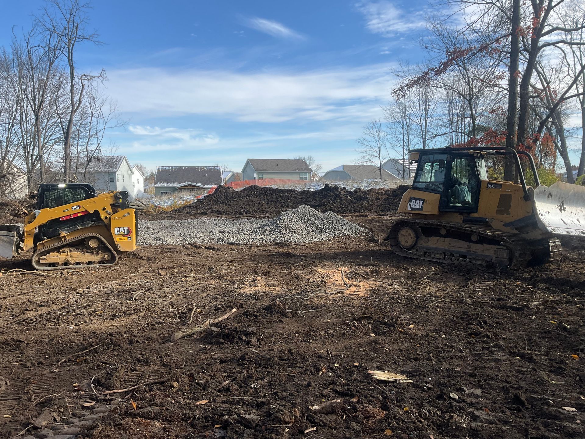 A bulldozer is demolishing a building with a large bucket.