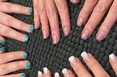 A group of women 's nails are arranged in a circle on a rug.