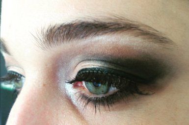 A close up of a woman 's eye with smokey eye makeup.