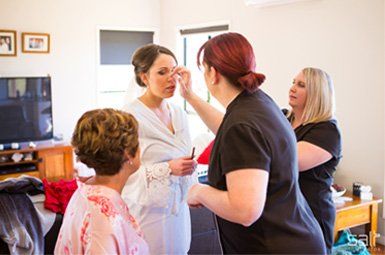 A group of women are getting ready for a wedding.