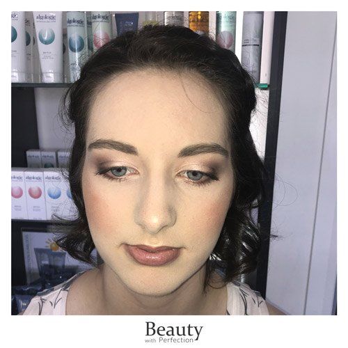 A close up of a woman 's face with makeup on.