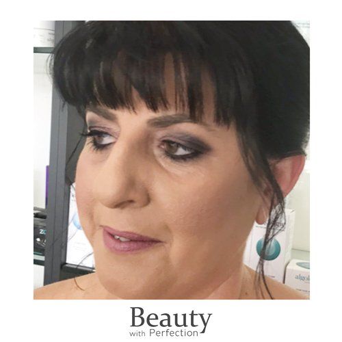 A close up of a woman 's face with makeup.