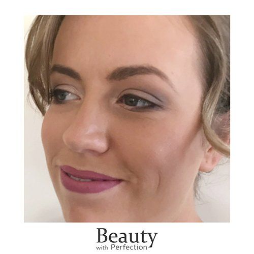 A close up of a woman 's face with makeup on.