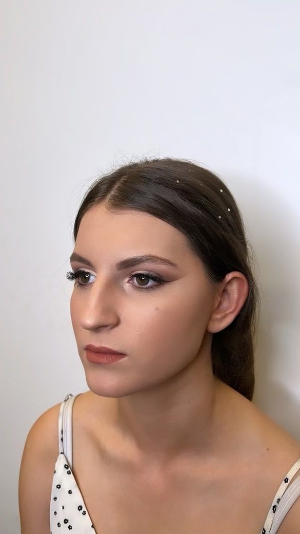 A close up of a woman 's face with a white background.