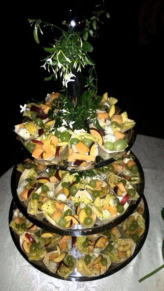 Una pila di tre piatti pieni di frutta su un tavolo.