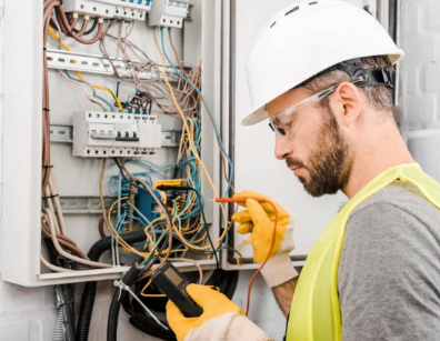 An electrician is working on an electrical box.