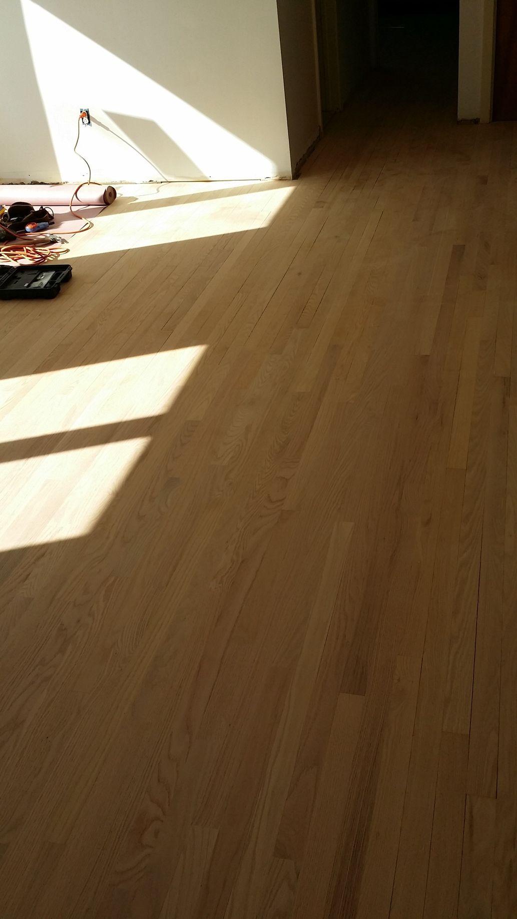 A wooden floor with a lot of shadows on it