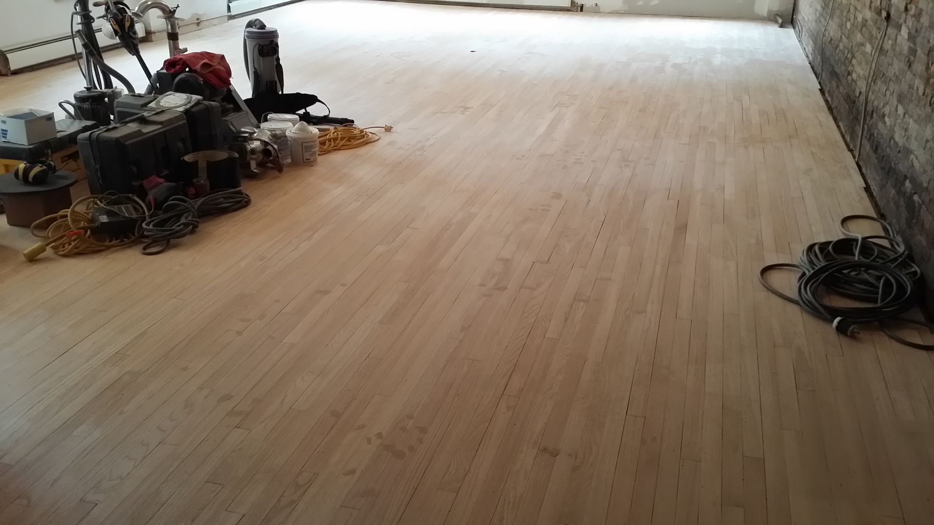 A wooden floor with a bunch of tools on it