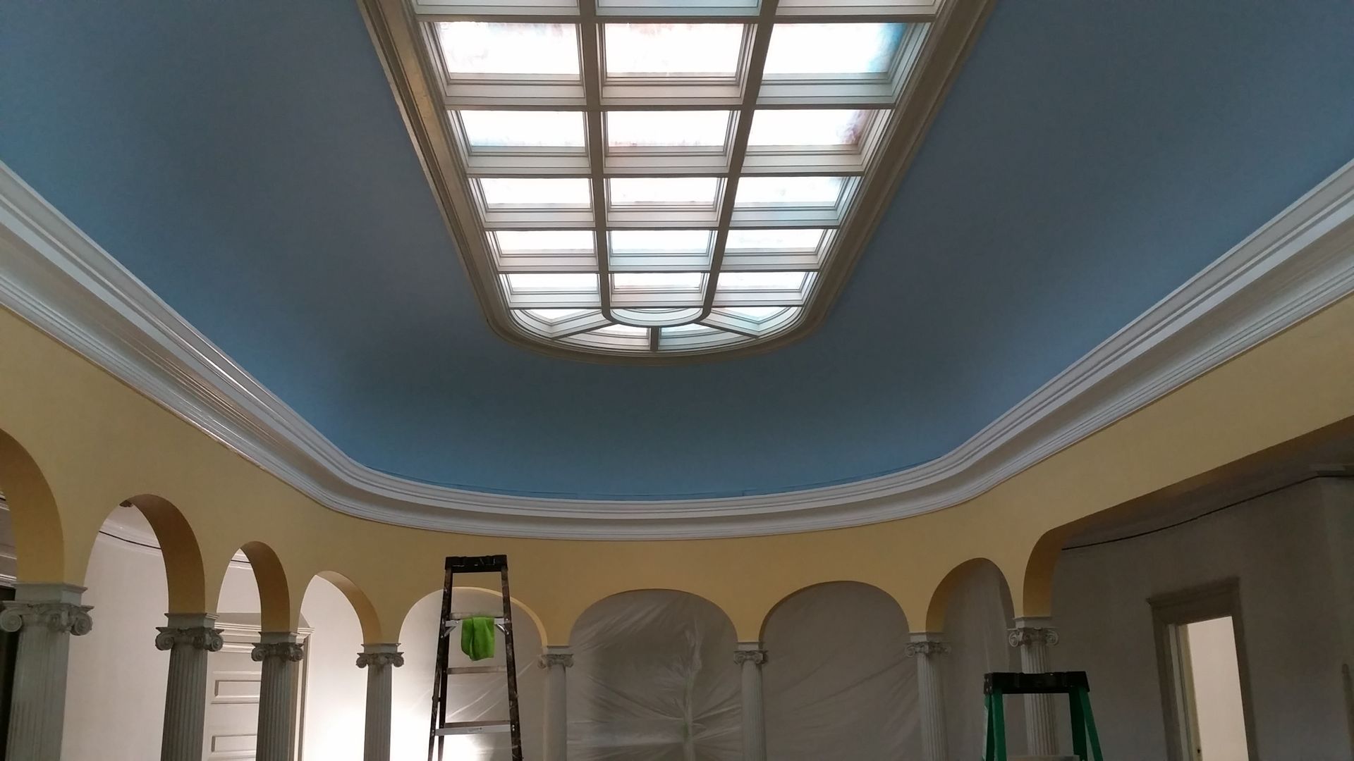 A room with arches and a skylight on the ceiling.