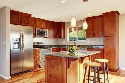 A kitchen with stainless steel appliances and wooden cabinets.
