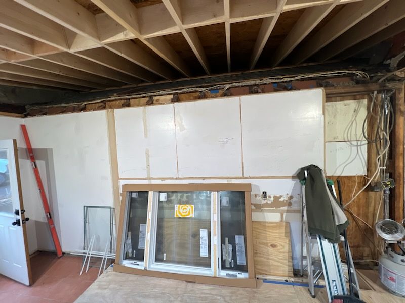 A room with a ladder and a window in it