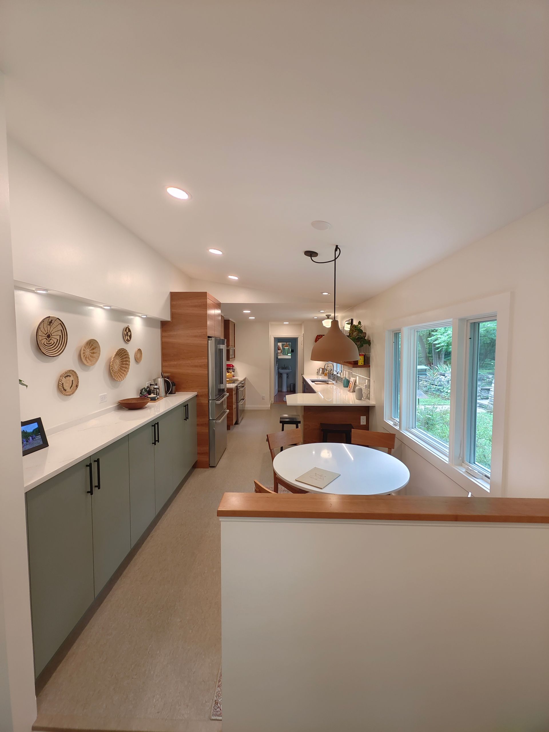 A kitchen with a table and chairs in it