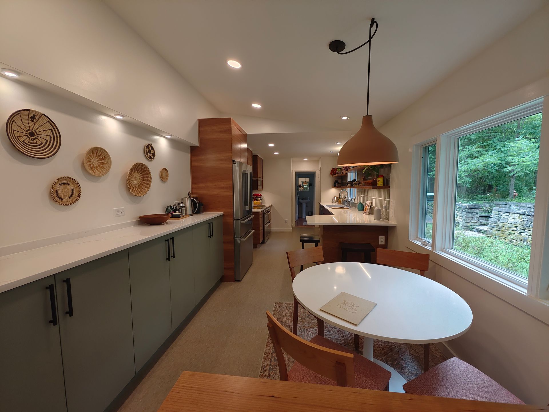 A kitchen with a table and chairs in it