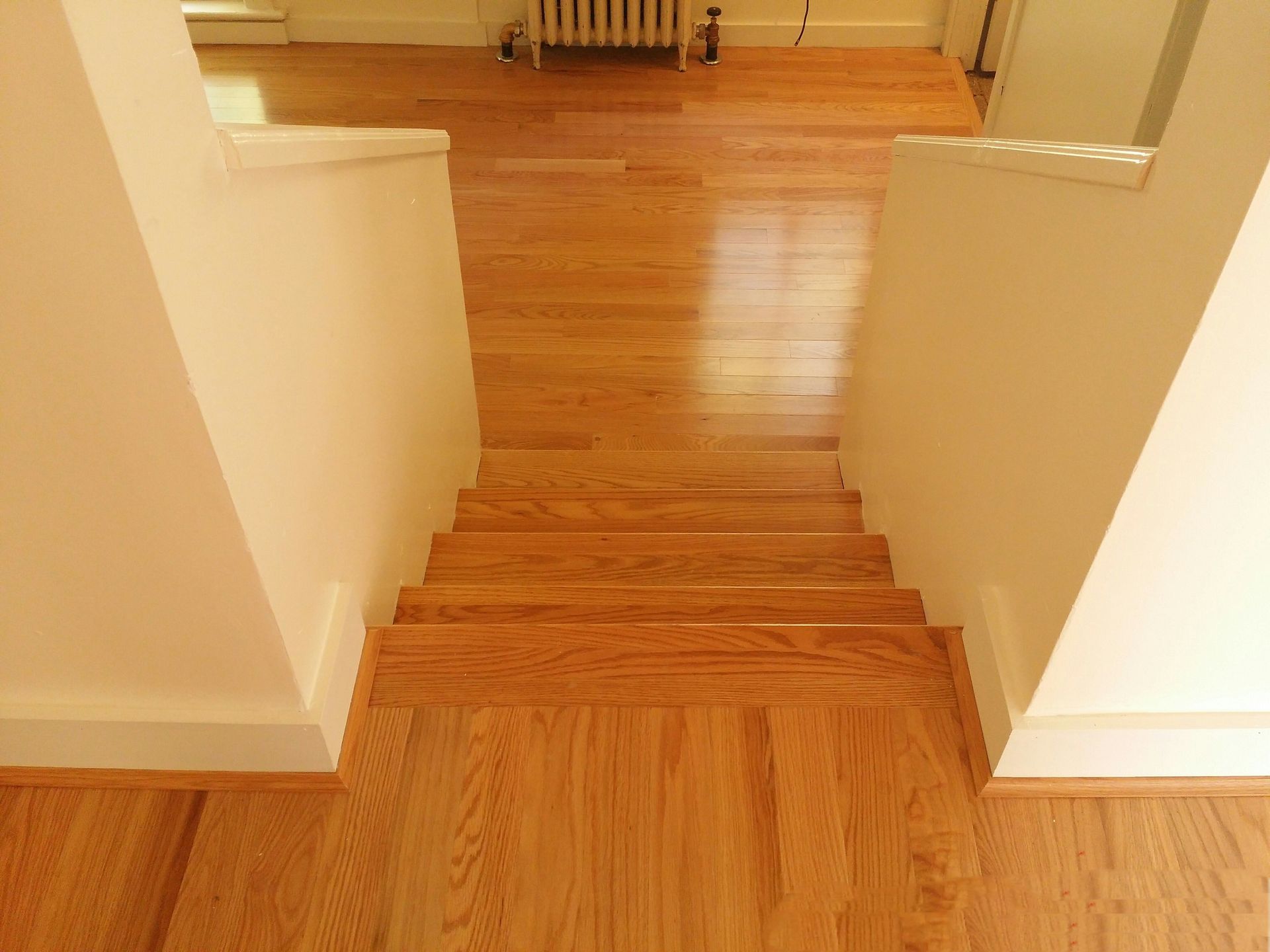 A wooden staircase leading up to the second floor of a house.