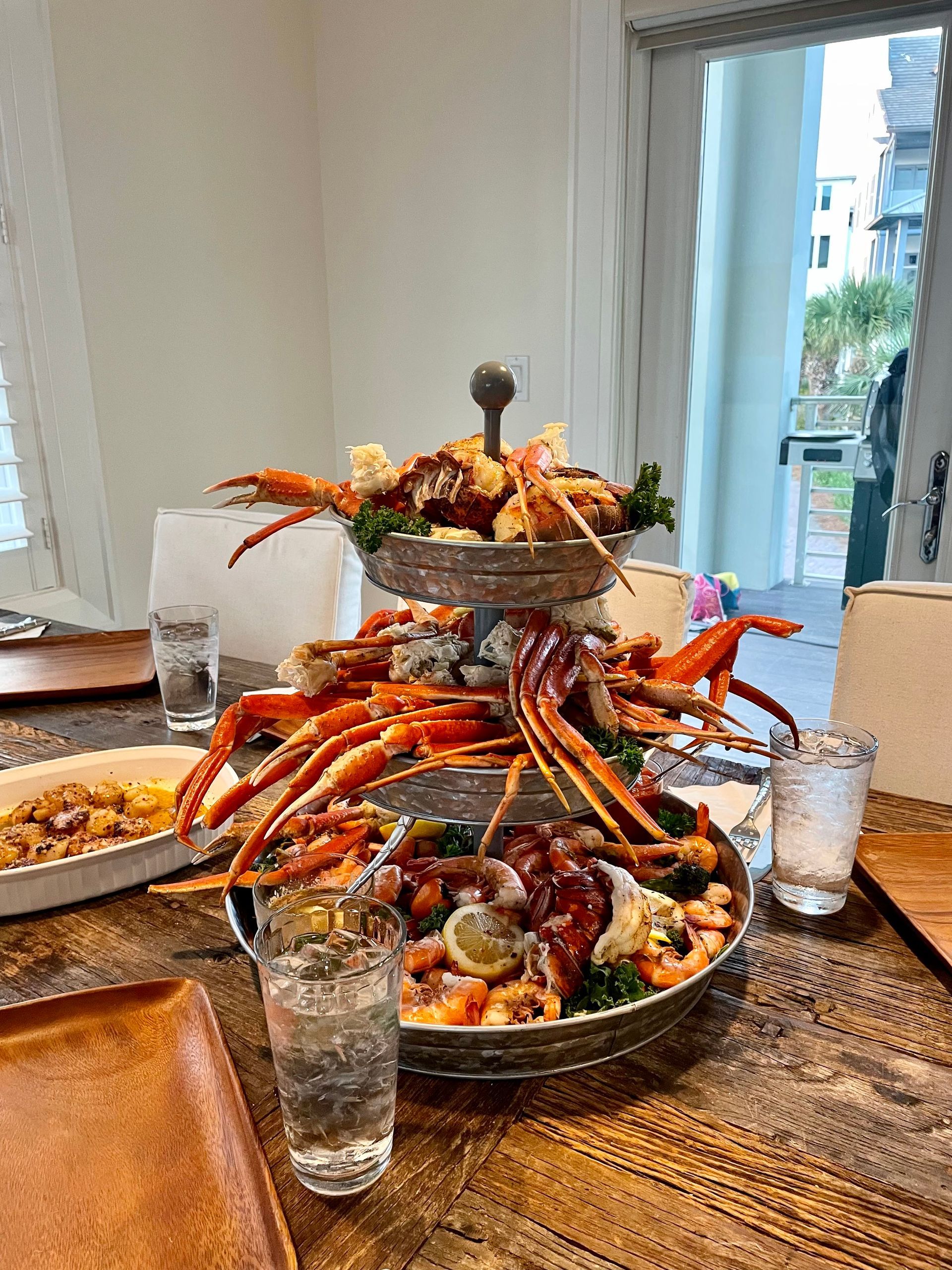a tray of seafood is sitting on top of a wooden table .— Mary Esther, FL — Bella Donna Catering