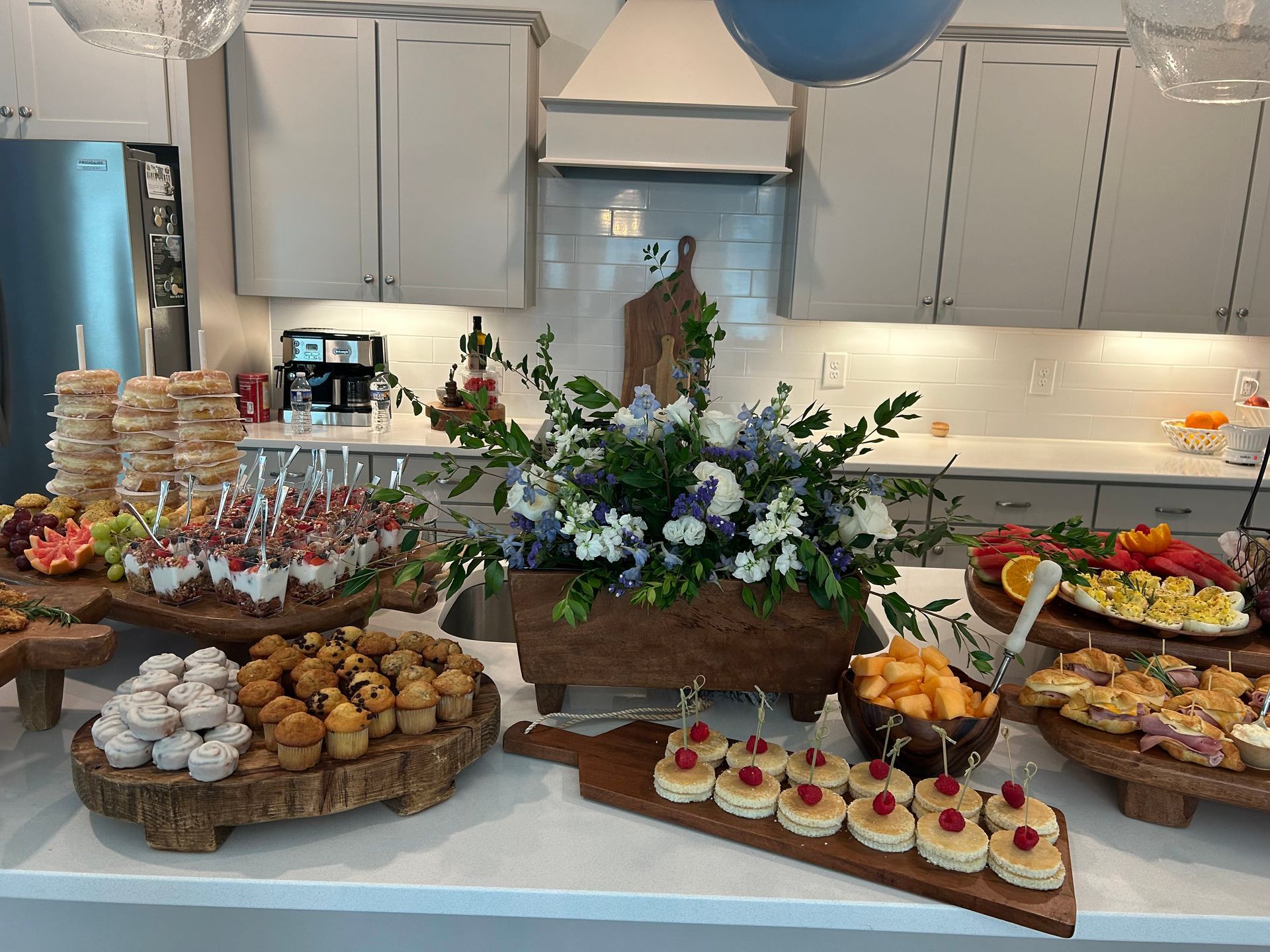 a buffet table with a variety of food on it in a kitchen . — Mary Esther, FL — Bella Donna Catering