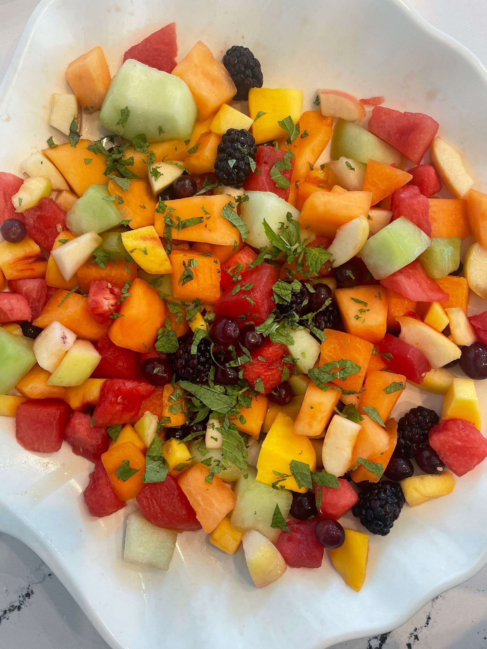 a white plate topped with a variety of fruits and berries — Mary Esther, FL — Bella Donna Catering