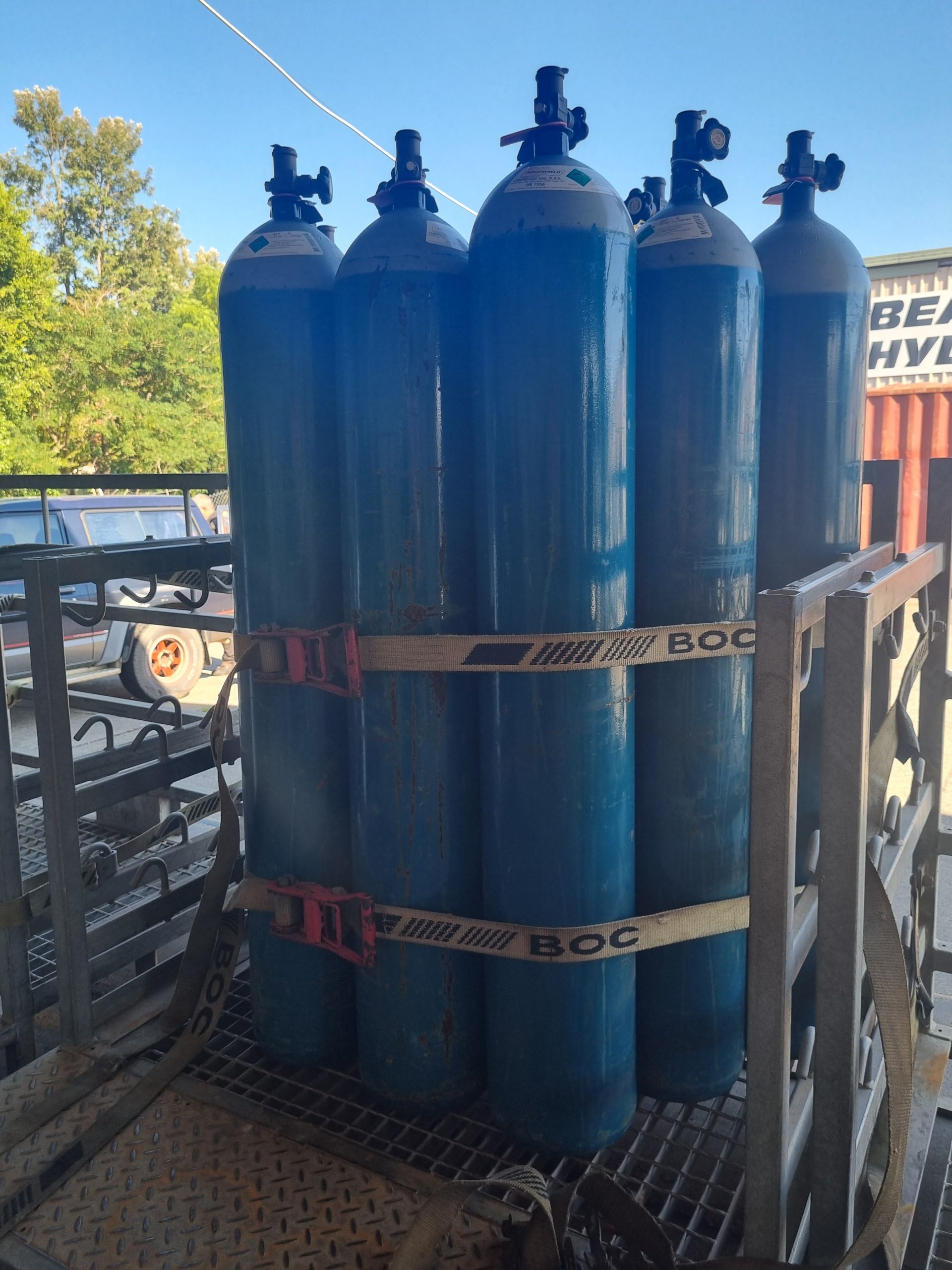 Cluster of blue gas cylinders secured on a metal pallet — Eastcoast Bearings & Hydraulics in South Grafton, NSW